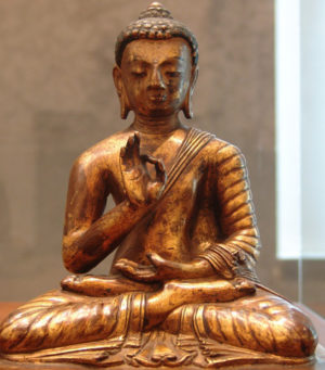 Photographie d'un statue représentant le Bouddha Amoghasiddhi, assis en position du lotus.